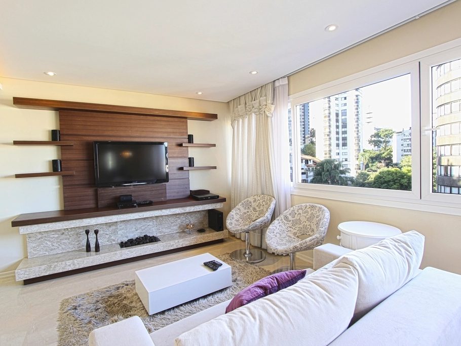 Living room with a warm wood-slat feature wall behind the media console